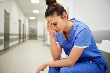 Female nurse suffering from headache