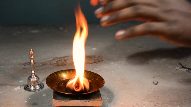 Closeup of hands taking blessings from pooja Aarti(The Hindu Ceremony of Light).
