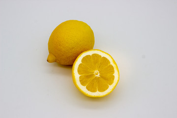 One lemon and half a lemon isolated image on a white background