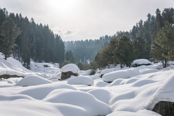 Boulders and rocks covered with snow in a mountain valley landscape