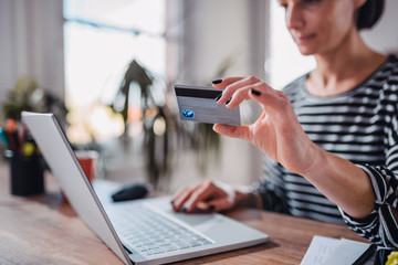 Woman shopping online and using credit card