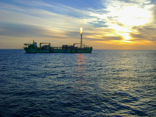 FPSO flaring offshore agains beautiful sunset