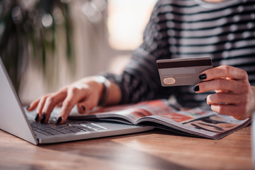 Woman shopping online and using credit card