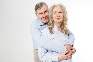 Happy senior family couple isolated on white background. Close up portrait woman and man with wrinkled face. Elderly grandparents people have fun. Smiling mature male and female. Copy space