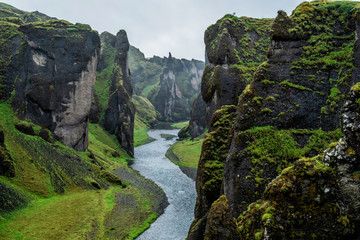 Unique landscape of Fjadrargljufur in Iceland. Top tourism destination. Fjadrargljufur Canyon is a massive canyon about 100 meters deep and about 2 kilometers long, located in South East of Iceland. - obrazy, fototapety, plakaty