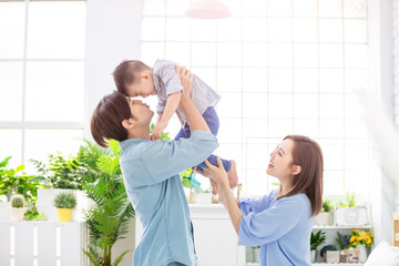 Happy family kiss their child © ryanking999