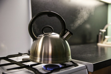 kettle with boiling water. the kettle boils on a gas stove. the kettle whistles on the gas. steam...