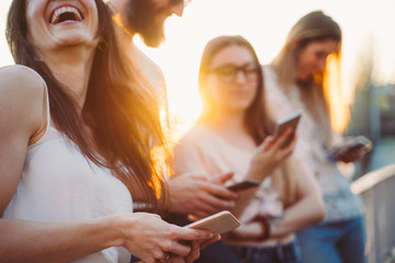 Group of friends watching media on a smartphone