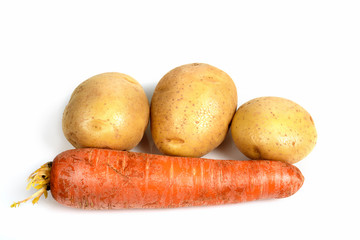 Carrots and potatoes on white background - vegetables