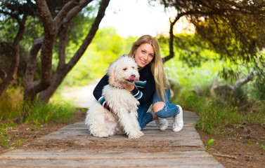 Young girl with her dog in a park