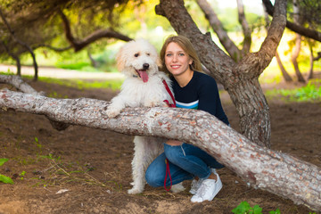 Young girl with her dog in a park