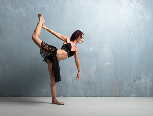 Ballerina dancing on grunge wall background