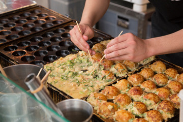 cooking Takoyakis at a street stand in Osaka