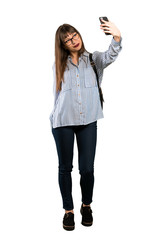 Full-length shot of Woman with glasses making a selfie