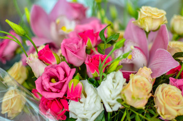Bouquet with orchids and roses on a beautiful background