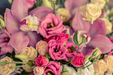 Bouquet with orchids and roses on a beautiful background