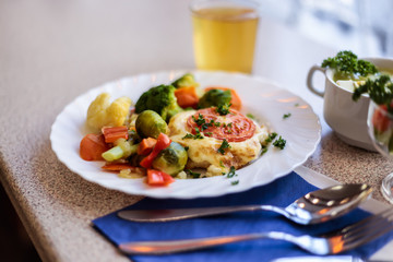 chop with vegetables and juice in a cafe