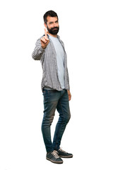 Fototapeta premium Handsome man with beard showing and lifting a finger over isolated white background