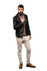 Handsome man with beard surprised and shocked while looking right over isolated white background