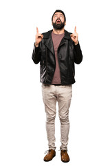 Naklejka premium Handsome man with beard surprised and pointing up over isolated white background