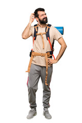 Fototapeta na wymiar Hiker man having doubts while scratching head over isolated white background