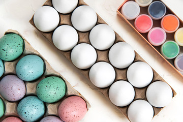 Eggs and paints on a white background. Coloring easter eggs