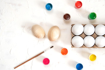 Eggs and paints on a white background. Coloring easter eggs