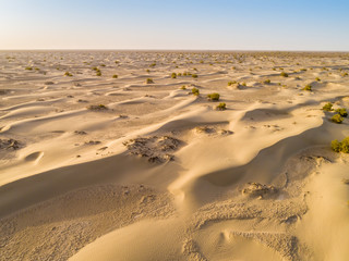 Fototapeta na wymiar Sundown in desert.Big sand dunes panorama. Desert or beach sand textured background. 