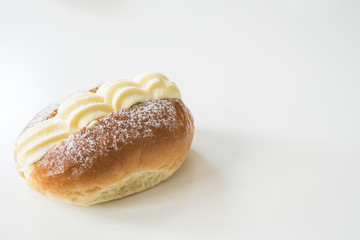 typical Dutch creamed sandwich called roombroodje or puddingbroodje. Against white background, copy space