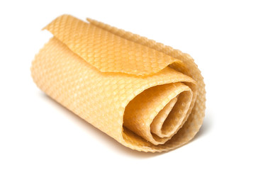 closeup of rolled bees wax on white background