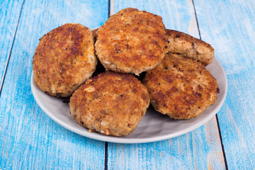cutlets on a grey plate, on a blue wooden background