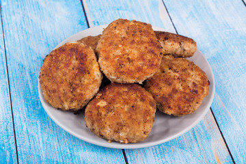 cutlets on a grey plate, on a blue wooden background