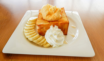 Dessert bread honey santos vanilla ice cream with whip cream banana fruit and honey bee
