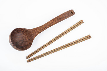 a wooden spoon and a pair of chopsticks on a white background