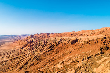 The Flaming Mountains are barren eroded red sandstone hills in Tian Shan Mountain range Xinjiang China. 