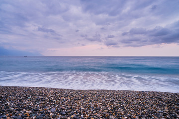 Beautiful scenic of ocean with sprawling stone covered beach at Qixingtan beach recreation area in Hualien city, Taiwan.