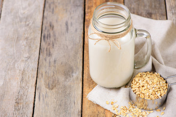 Vegan non dairy  oat milk  in a jar with copy space