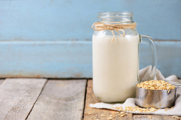 Vegan non dairy  oat milk  in a jar with copy space