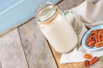 Fototapeta na wymiar Vegan non dairy pecan milk in a jar with copy space