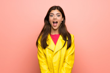 Fototapeta premium Teenager girl over pink wall with surprise facial expression