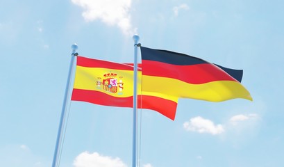 Germany and Spain, two flags waving against blue sky. 3d image