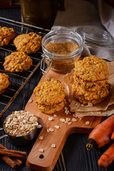 Carrot oatmeal cookies with with cranberries and cinnamon on the rustic background