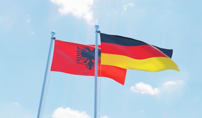 Germany and Albania, two flags waving against blue sky. 3d image