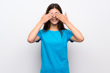 Teenager girl with blue shirt covering eyes by hands