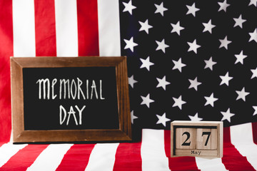 memorial day lettering on chalkboard near wooden cubes with date and flag of america
