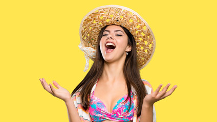 Teenager girl on summer vacation smiling a lot over isolated yellow background