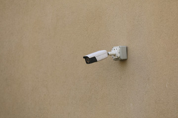 security camera on the yellow wall