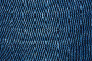 Naklejka premium Denim jeans texture background with torn. The texture of the colored cotton fabric. Stitched texture jeans background. Fashion jeans button. Pocket and rivet on jeans. Fiber and fabric structure.