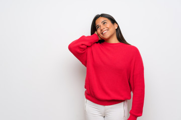 Young Colombian girl with red sweater thinking an idea