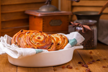 Fresh homemade pain au raisins croissant  over wooden background